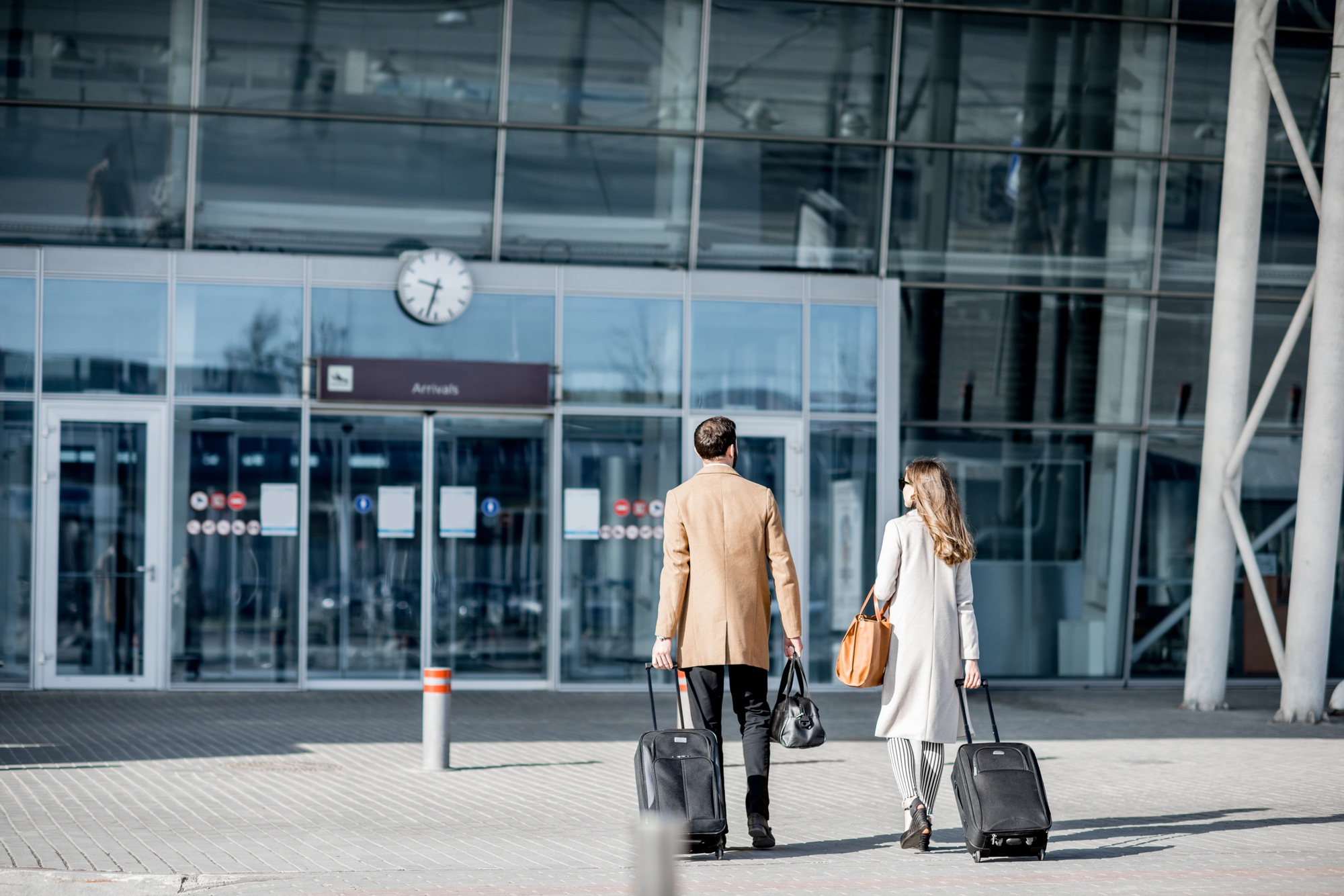 Business couple walking to the airport