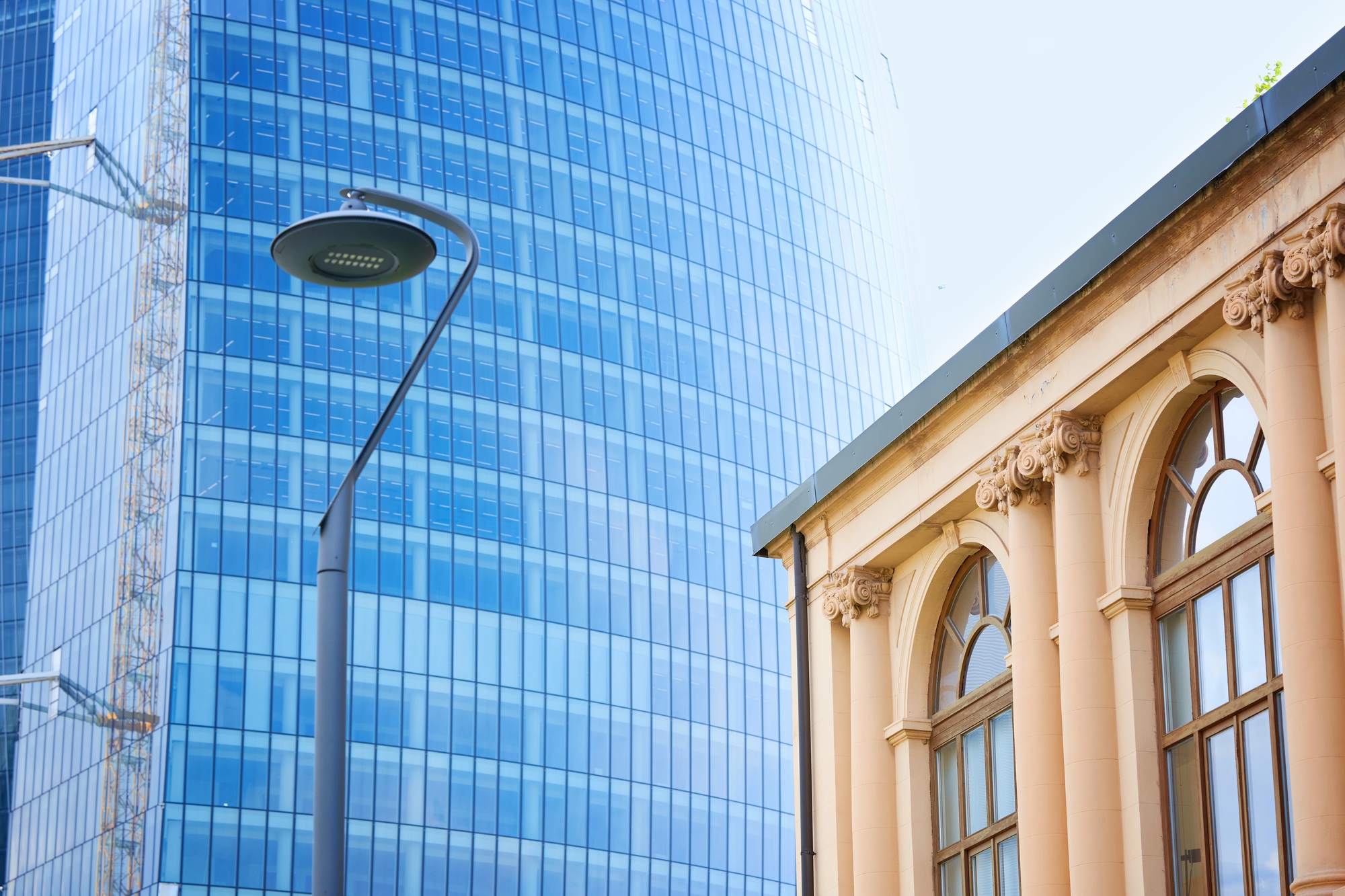 Old building in front of Generali Tower or Hadid Tower in CityLife area, Milan, Italy.